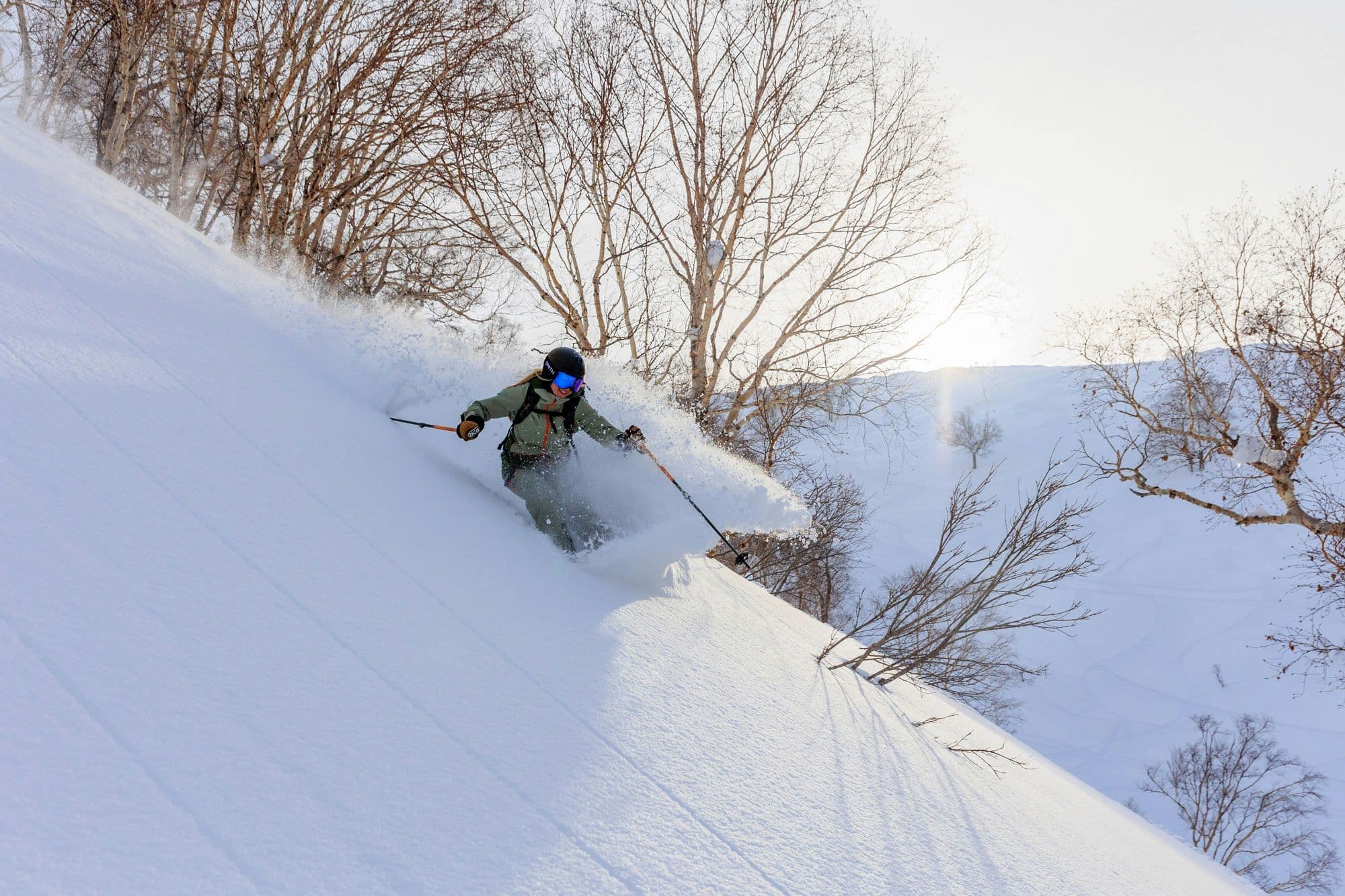 Skier in enjoying turns in the Iwate powder