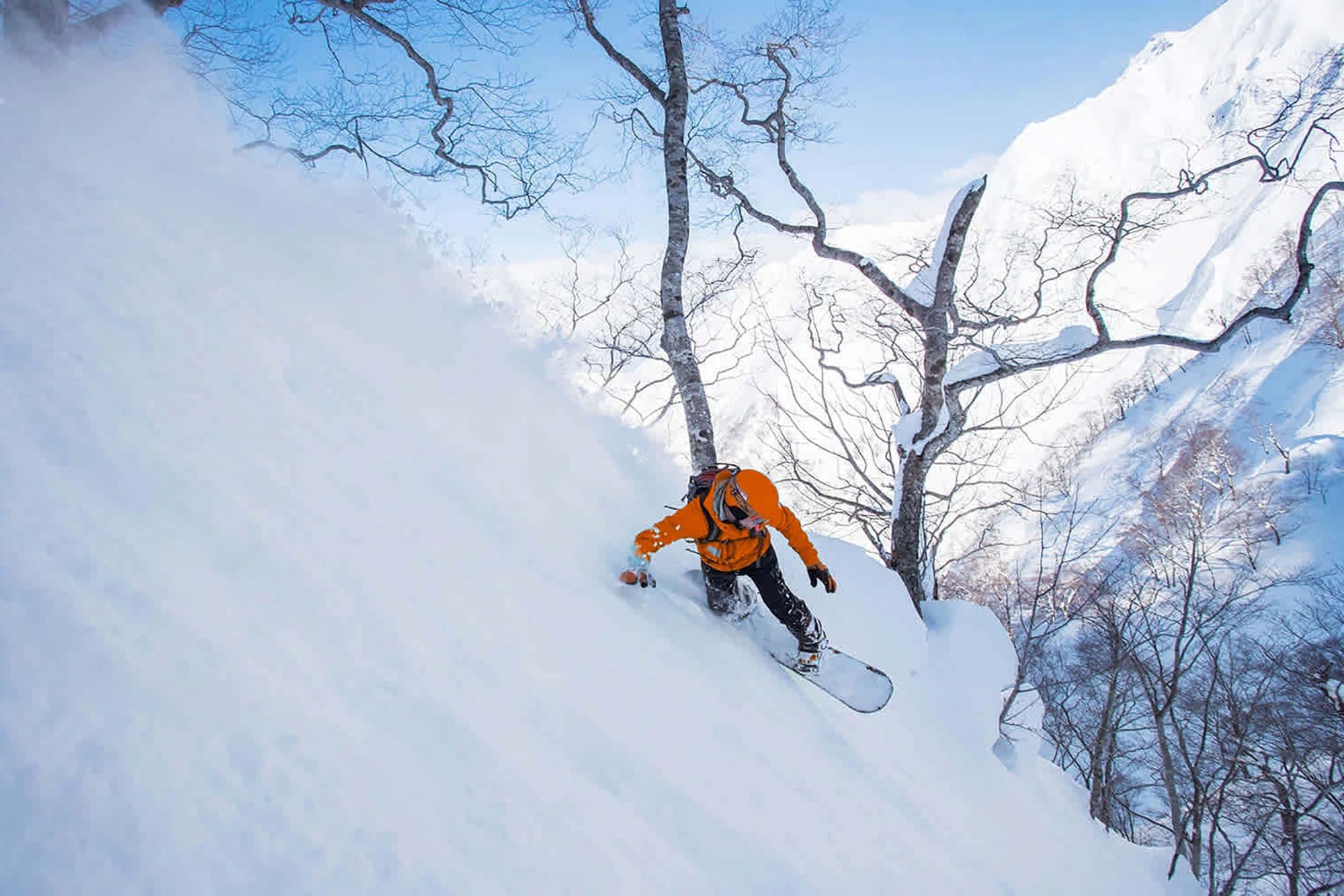 Snowboarder in the backcountry in Gunma putting in some big turns