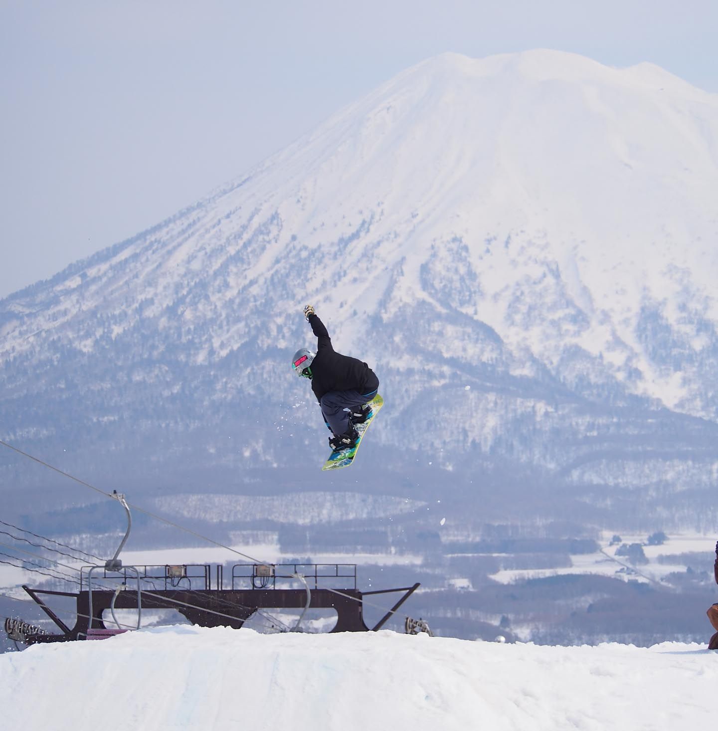snoboarder sending it off a kicker at Niseko