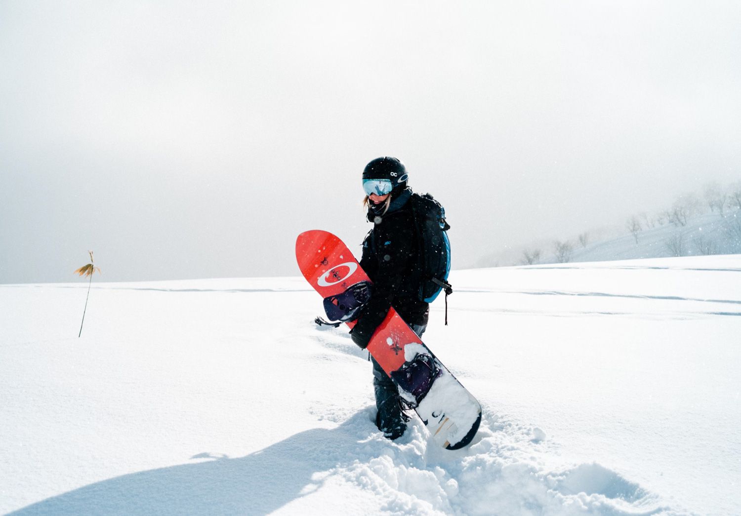 girl with her snowboard in some solid japow at Moiwa