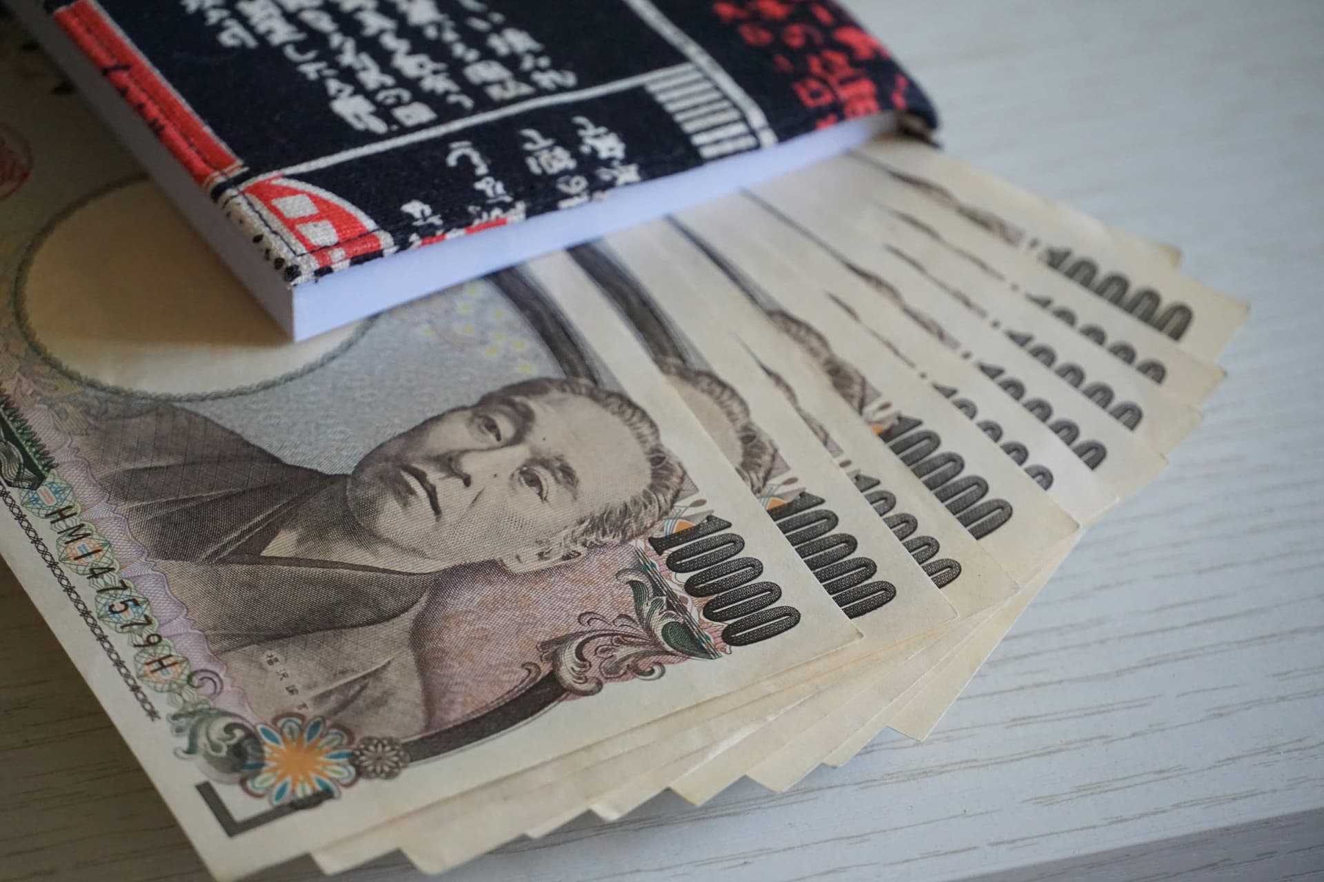 Japanese Yen notes fanned out in a book