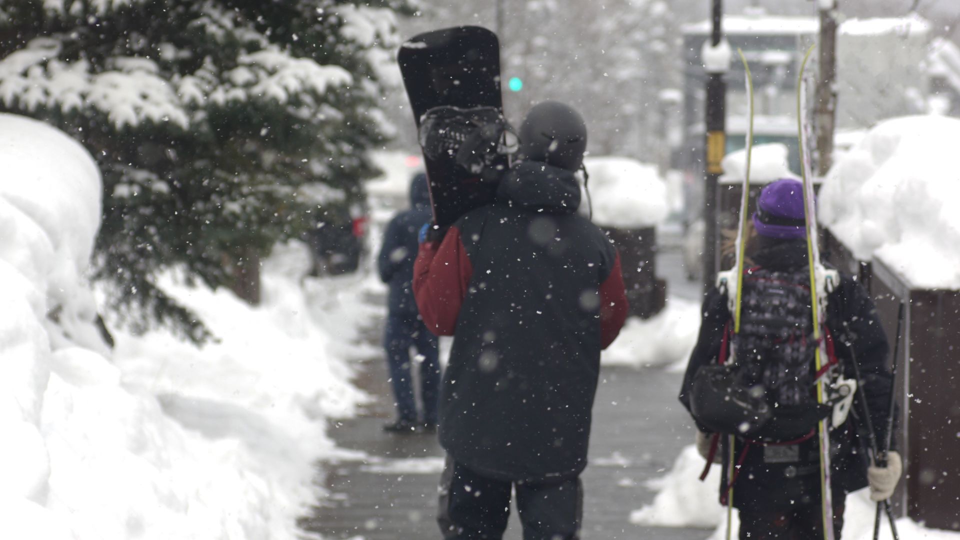 snowboarder walking the streets of Niseko in the snow