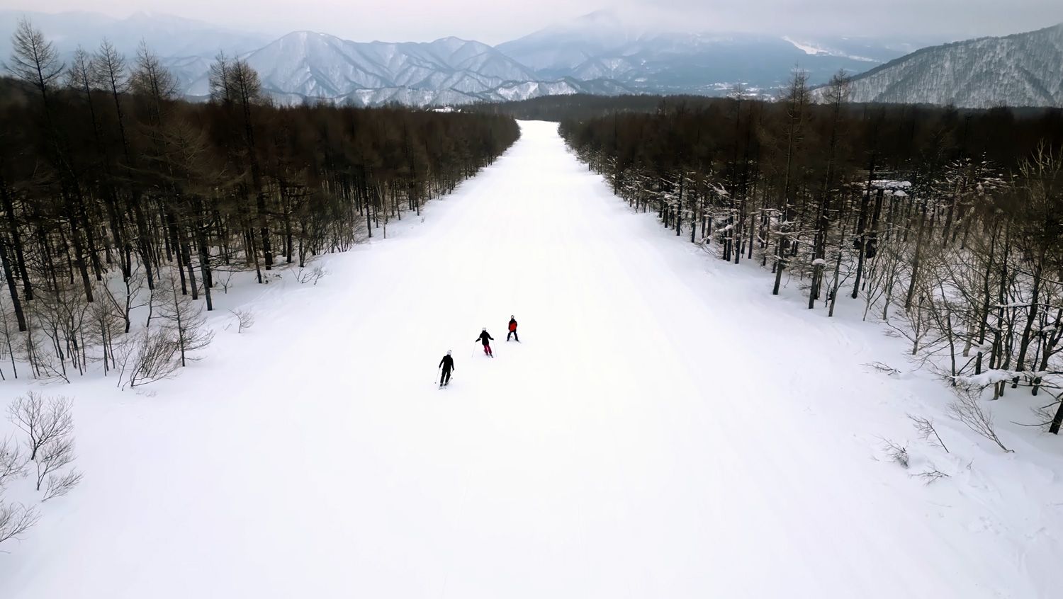 Skiers enjoying a long piste run at Grandeco