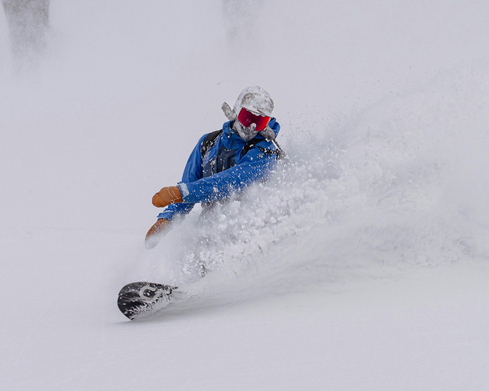 snowboarder making big japow turns | Nagano area