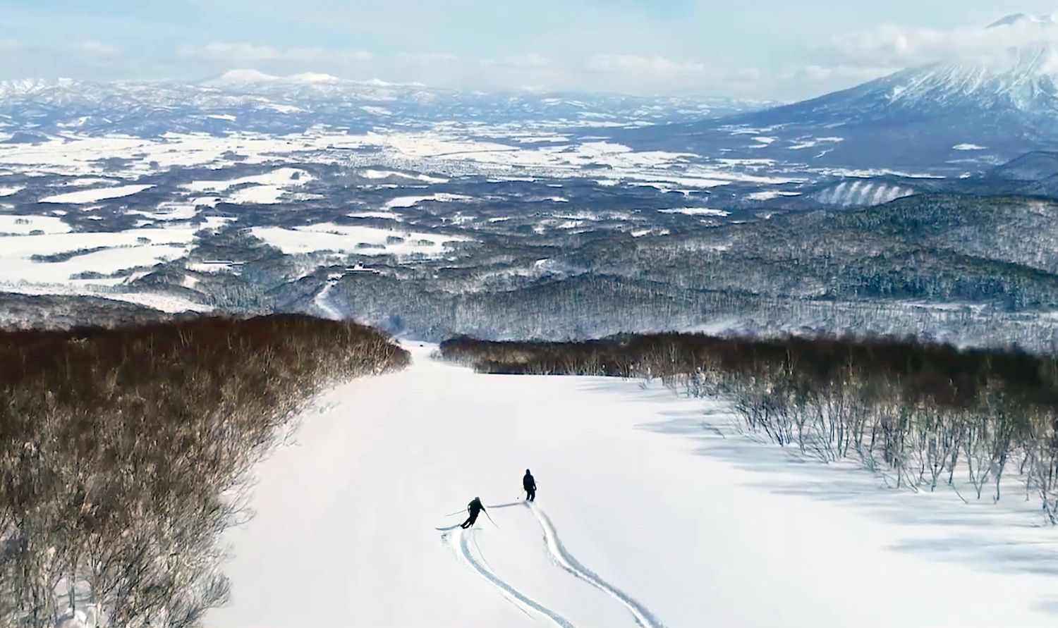 Hanazono skier and snowboarder enjoying an empty run of fresh pow